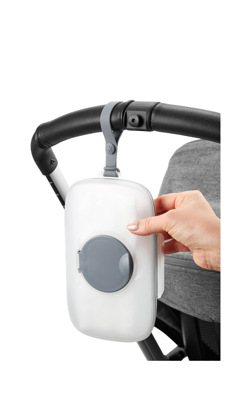 Portable baby wipes dispenser attached to stroller handle for quick diaper changes outdoors
