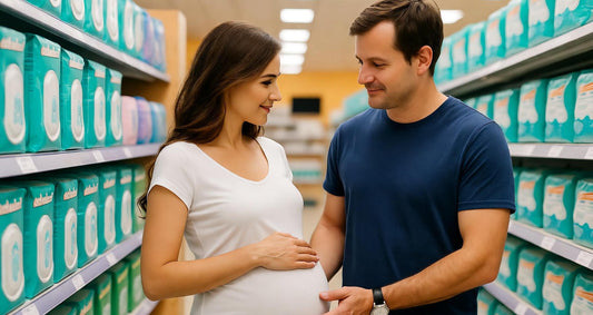 Expecting couple choosing diapers at the store before baby arrival