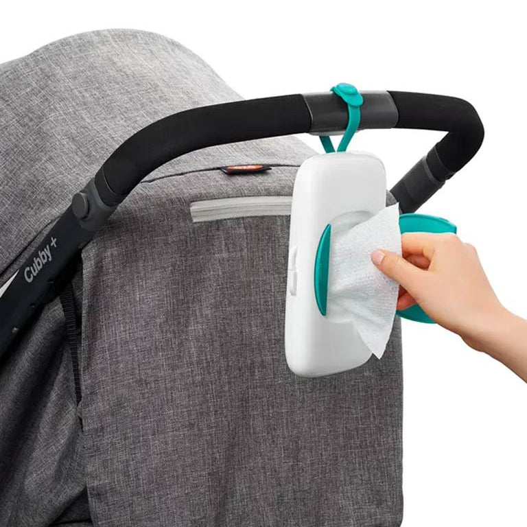 Hanging wipes dispenser case with green strap on stroller for easy access